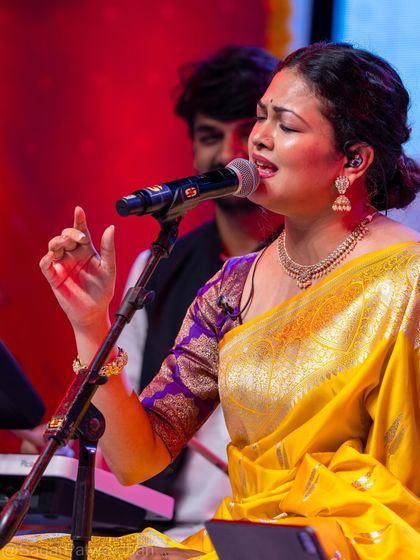 This shot captures Priyanka Barve in her element, singing passionately. The styling was designed to be elegant and non-restrictive for her performance.