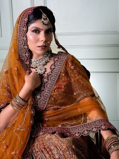 This angle shows the beautiful draping of the dupatta and how the makeup holds its own, with a focus on the sharp, defined eye makeup and contour.