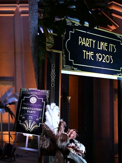 The entrance to the Great Gatsby party, featuring a custom-designed sign and art deco details. The first impression sets the stage for the entire themed experience.