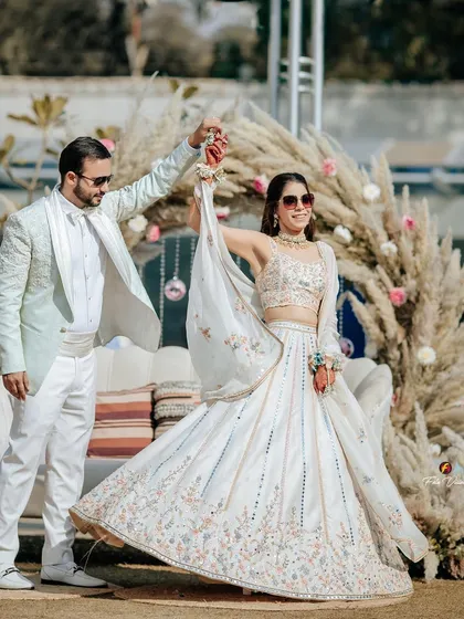 Anshay and Sahiba share a dance at their Mehendi. The bohemian style decor with pampas grass provides a trendy and beautiful backdrop for their couple portraits.