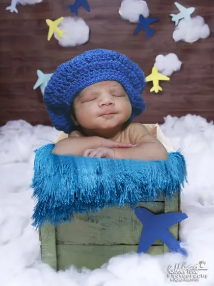 A sleeping baby in the same airplane-themed setup.