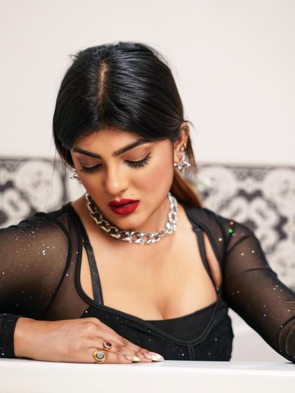 A more contemplative moment from the same shoot. The downward gaze and soft lighting create a different, more subdued mood.