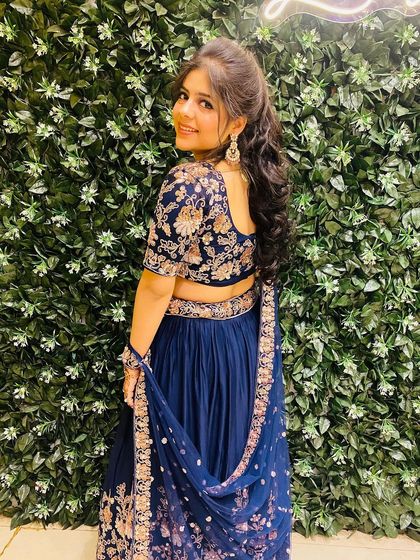 The back view of the navy blue floral lehenga, showing the detailed work on the blouse. It’s all about the little details that make you feel special.
