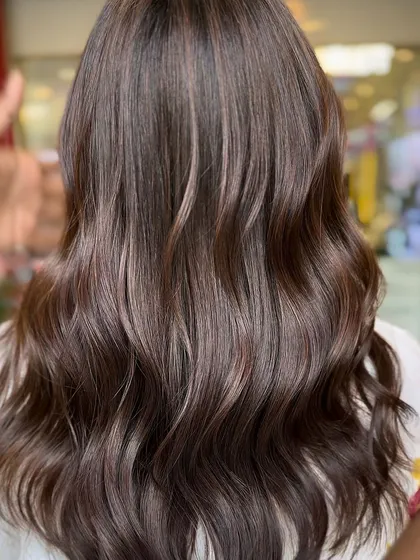 A beautiful balayage with soft, natural-looking highlights. This is a great example of a timeless hair color transformation that adds brightness and dimension.