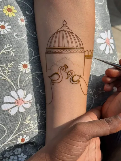 A minimalist design in progress. This piece features two lovebirds in front of a dome, a simple and romantic motif that tells a story without needing a full hand of henna.