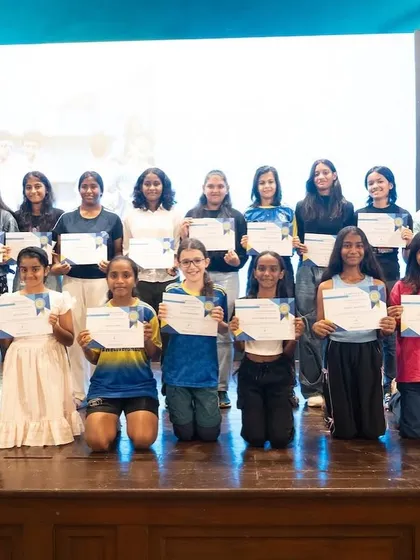Our girls' teams proudly display their certificates on stage during the Bravo Xcelerate Annual Awards Day. This image captures a moment of recognition for their hard work and success throughout the season.
