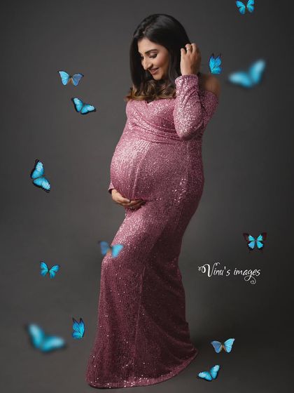 A touch of magic. This portrait adds whimsical blue butterflies fluttering around the mother-to-be in her sparkling pink gown, symbolizing transformation and new life.