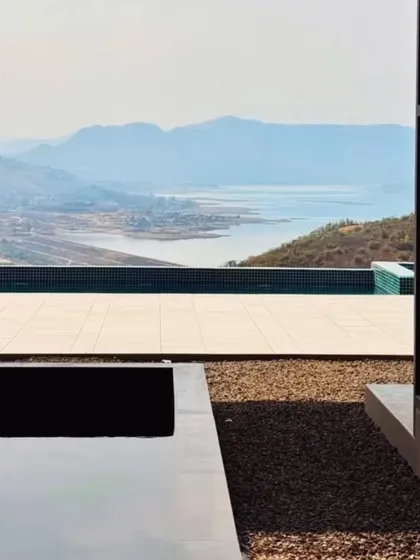 A detail of the infinity pool at the Amarja Pawna project. The design creates a seamless visual transition between the pool and the lake beyond, making the architecture feel like a natural extension of the landscape.