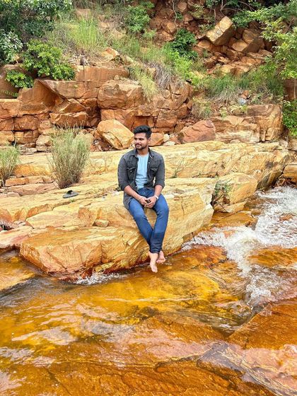 Sitting on the warm rocks by the stream, a perfect way to connect with nature.