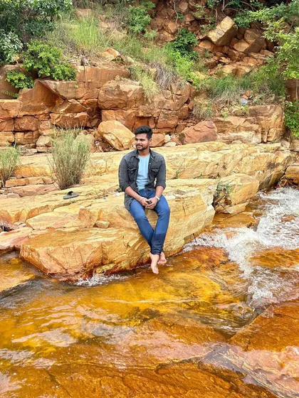 Sitting on the warm rocks by the stream, a perfect way to connect with nature.