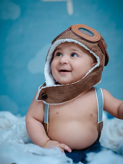 Sitter sessions are perfect for capturing that 6-9 month old personality. This little aviator, with his expressive eyes and adorable pilot hat, is ready to fly into his next big adventure.