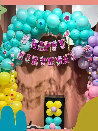 A rainbow of fun! This colorful butterfly-themed balloon arch is perfect for a bright and cheerful birthday celebration.