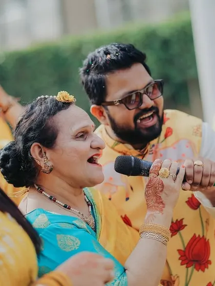 Music, dance, and family. A guest singing and enjoying the moment with a family member is a perfect example of the candid interactions that make a wedding special.