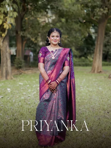 An elegant solo portrait of the bride, Priyanka, in her beautiful purple saree for her engagement function.