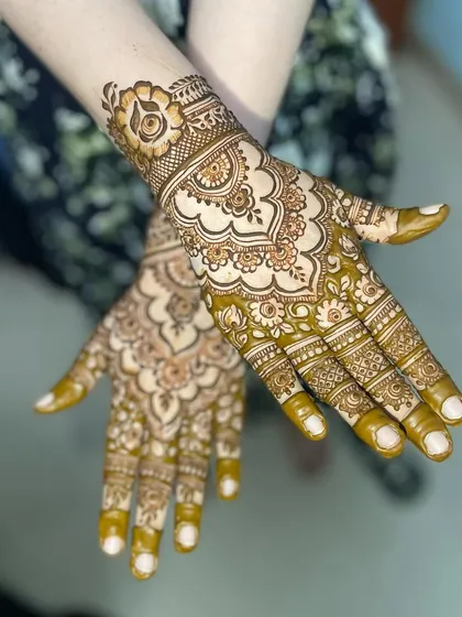 I love how this design turned out, with its central mandala and detailed finger work. The use of negative space around the main elements really makes them stand out.