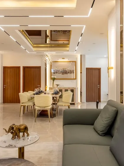 A closer look at the open-plan living space, highlighting the seamless flow into the dining area. Notice the custom wall paneling, statement art, and elegant furniture that combine to create a cohesive and inviting environment for family and guests.