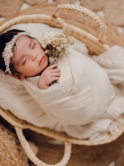 So tiny and perfect, sleeping peacefully in a rustic basket. The natural textures of the jute rug and woven basket create a warm, organic feel for this newborn portrait session.