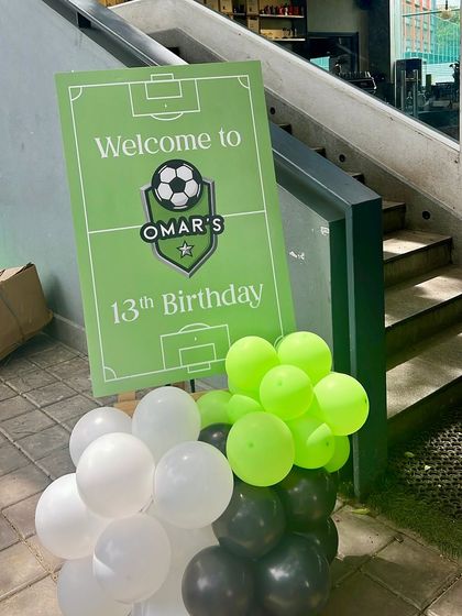 A welcome sign for Omar's 13th birthday, designed to look like a soccer field. It's a great way to introduce the theme right as guests arrive.
