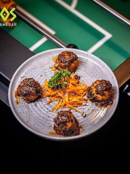 A fiery burst of flavor. Our Blazing Chicken Cheese Balls are placed right on the foosball table, ready for the players.