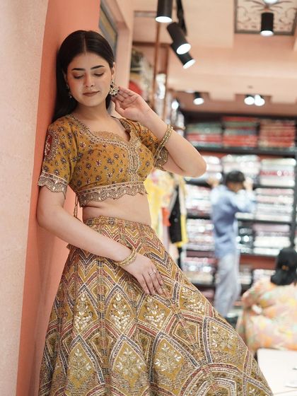 Step into the limelight with this embellished yellow lehenga. The vibrant color and intricate work radiate joy and elegance.