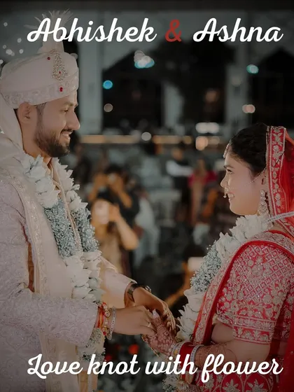 A close-up of the Varmala exchange, this image focuses on the connection between the bride and groom. The title "Love knot with flower" perfectly describes this central ritual of an Indian wedding.