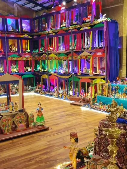 The vibrant colors of the Mahotsava are on full display here. The strategic use of lighting and colorful fabrics transforms the space, making each diorama a distinct world for visitors to explore.