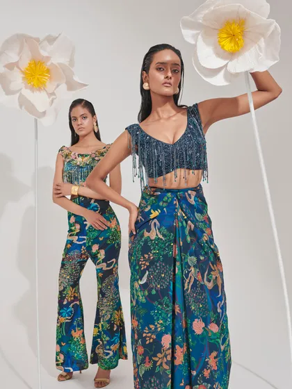 This shot features two models in coordinated blue printed ensembles. I styled them in a sharara set and a draped skirt with a fringed top to showcase the versatility of the print across different modern silhouettes.