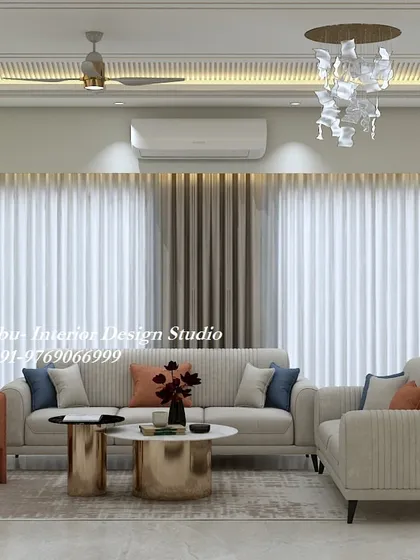 This living room uses a simple color palette of cream and orange to create a warm and inviting space. The vertically-striped sofas and metallic coffee tables add a touch of modern flair.