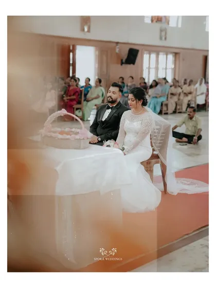 The couple seated during their church ceremony, a moment of quiet reverence and commitment.
