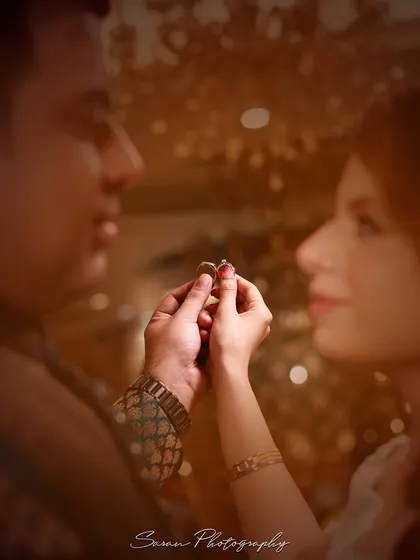 A soft-focus, artistic shot of a couple holding their engagement rings together.