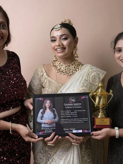 A proud moment with a graduate who excelled in her final exam, creating a beautiful white and gold bridal look.