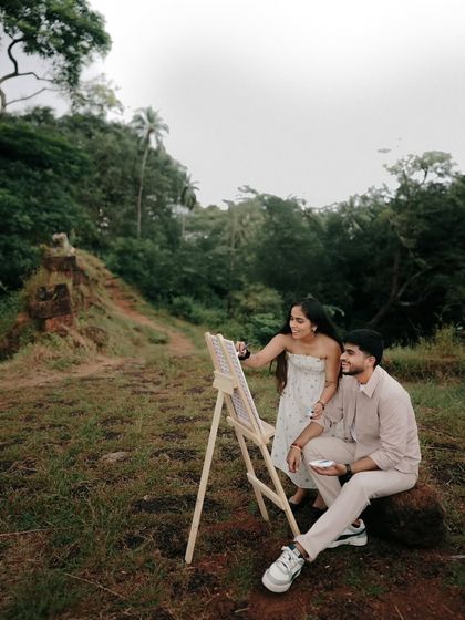 A serene moment from the pre-wedding shoot, where the couple shares a quiet connection amidst nature. The lush greenery provides a beautiful contrast to their calm presence.