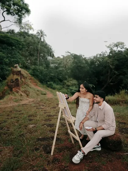 A serene moment from the pre-wedding shoot, where the couple shares a quiet connection amidst nature. The lush greenery provides a beautiful contrast to their calm presence.