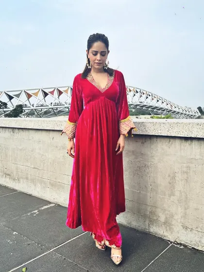 A pop of pink for Nushrratt Bharuccha in Ahmedabad. This velvet maxi dress with embellished cuffs is a comfortable yet glamorous choice for travel and promotional events.