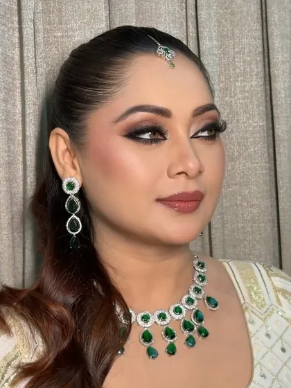 A stunning profile shot that showcases the sharp winged eyeliner and the beautiful contouring that defines her features.