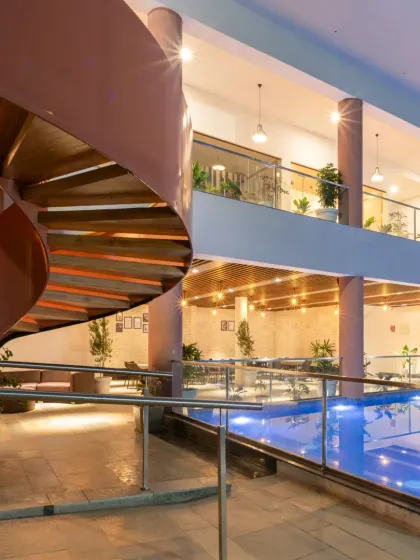 Another perspective of the Sona Vistaas staircase, highlighting its helical form as it connects the different levels of the clubhouse. It is a seamless blend of movement, structure, and visual drama.