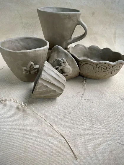 A duplicate of image 30, showing the collection of unfired hand-built pieces. Each item reflects the individual creativity of the student who made it.