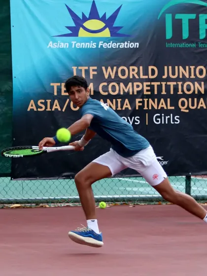 A dynamic shot of Tavish Pahwa hitting a forehand on the run during the ITF World Junior Team Competition. This demonstrates the ability to generate power even when under pressure.