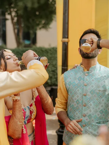 A fun and candid moment of the couple taking a celebratory shot. These are the unscripted memories that make a wedding special.