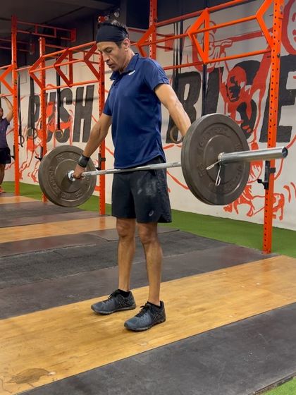 This client demonstrates the starting position for a hang snatch, with the barbell just above the knees. This variation is excellent for teaching how to use the hips to generate power.