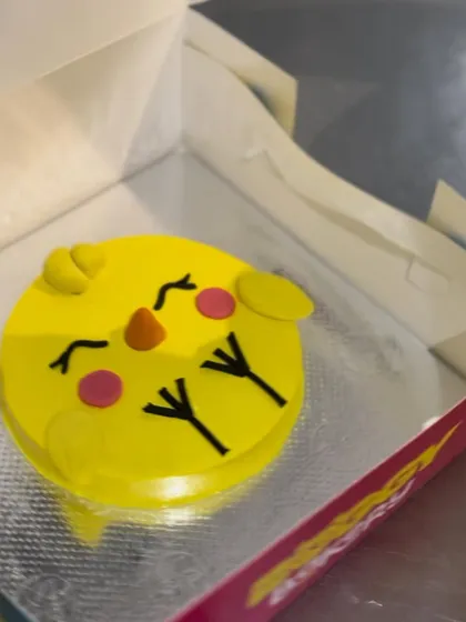 The finished Easter chick cake, boxed and ready for delivery. It's a fun and festive treat for the spring season.