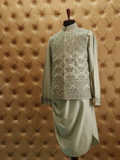 This kurta pajama and jacket set in a lovely shade of greyish blue is one of our most loved curations, perfect for any special occasion.