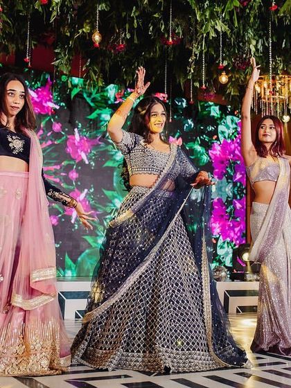 A fun and stylish performance by the bride's sister and her friends. This photo captures the energy and attitude of a modern sangeet dance.