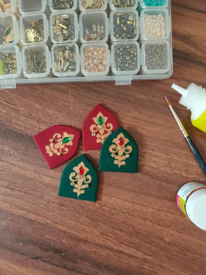 A glimpse of my work-in-progress materials. You can see colorful fabric components, beads, threads, and hand-painted pieces all waiting to be turned into beautiful jewelry.