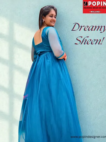 "Dreamy Sheen". This image captures the graceful back and flowing skirt of the teal blue gown, perfect for a party or pre-wedding photoshoot.