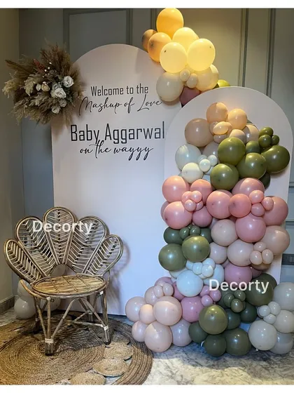 A personalized backdrop for the 'Mashup of Love' baby shower, featuring a stylish peacock chair for the mom-to-be.