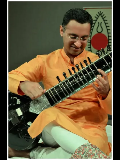 A smiling shot from the SPIC MACAY performance, showing the joy of sharing music with students.