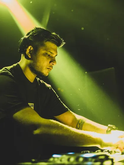 A focused, atmospheric shot of me mixing tracks at Raahi. This captures the artistry and concentration that goes into every set.