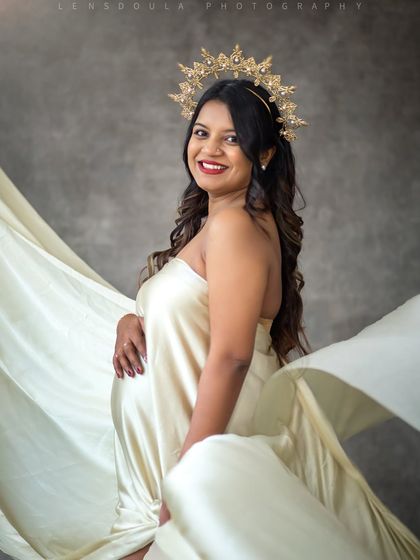 Wrapped in silk and crowned in love. This regal studio portrait uses a simple drape and a crown to create a goddess-like image.