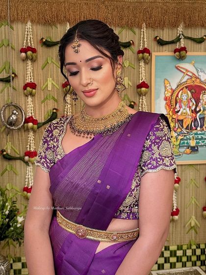 A beautiful look for a Pellikoduku event, featuring a rich purple saree and classic gold jewellery.